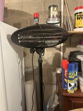 Plug in patio heater on an adjustable stand.