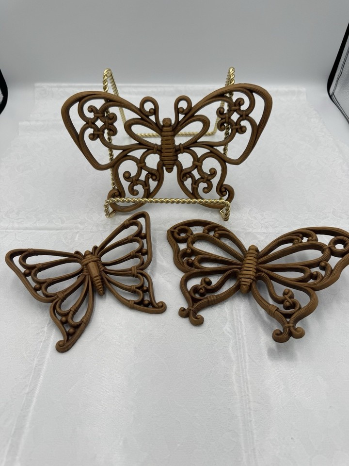 A set of three original 1970s Homco plastic butterfly wall hangings — kitschy, whimsical, and enjoying a massive style comeback in boho and maximalist interiors.