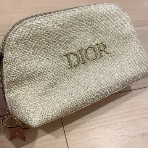 Pochette tissu blanc logo Dior avec breloque étoile paillettes or