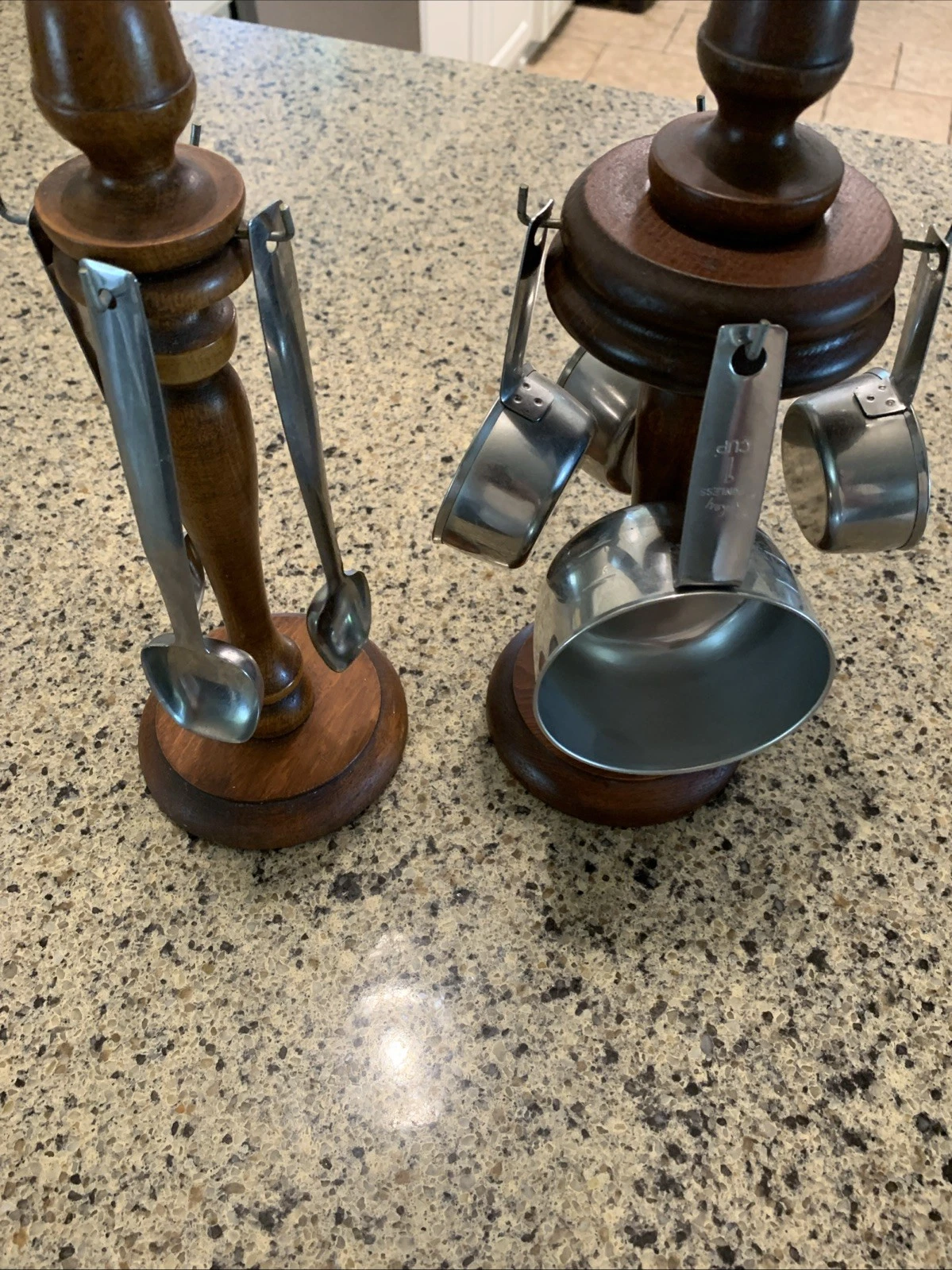 Two Wooden Stands With Four Cups And Three Spoons