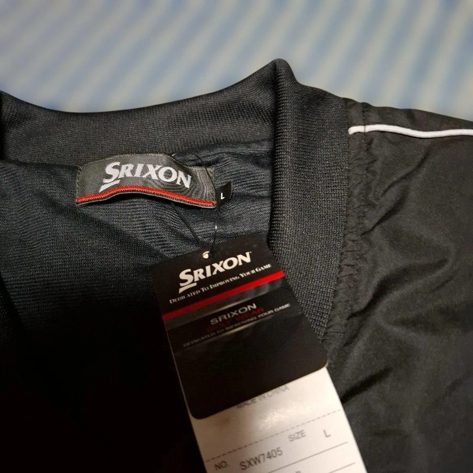 Chaqueta de golf Srixon negra de manga larga con mangas desmontables, líneas laterales blancas Foto 4 de 4