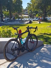 Guru Photon 57cm Carbon Road Bike With Air travel case.