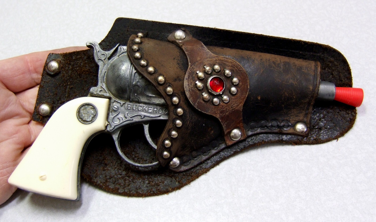 Vintage BUCKEROO Diecast Metal Cowboy Toy Cap Gun with Ornate Leather