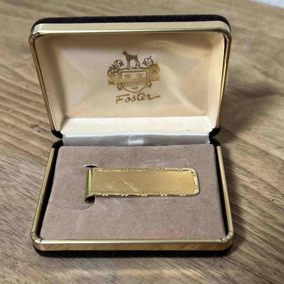 A sleek mid-century gold-tone money clip from Foster, still in its original box — the kind of understated gentleman's accessory that feels like it came from a 1960s haberdashery.