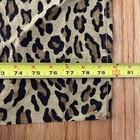 Brown and black leopard print cotton sheet with yellow measuring tape showing dimensions.