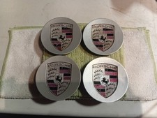 Genuine Porsche Silver Wheel Center Hub Caps with Colored Crest Set of 4.