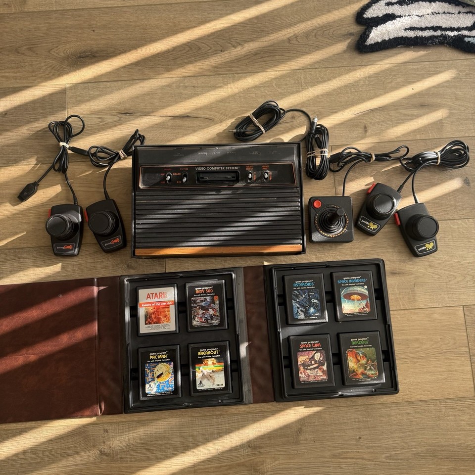 A complete, ready-to-play Atari bundle with 8 games, 4 controllers, a joystick, AND a case — this is a proper retro gaming time capsule, not just a dusty box of parts.