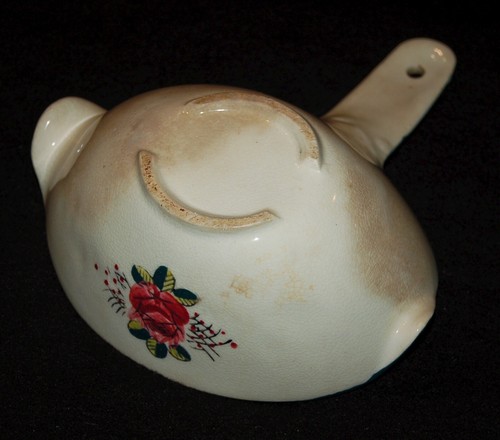 White ceramic gravy separator with red and green floral pattern, made in USA during 1940s.