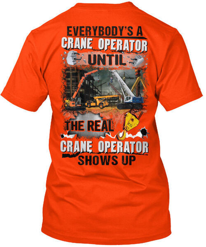Orange crane operator T-shirt with black “Everybodys A Crane Operator Until” text and visible crane in background.