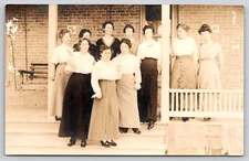 Postcard RPPC Woman Holding Dog Group of Women on Front Porch Bunch of Daisies