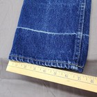Blue denim high-rise straight leg with white contrast stitching, yellow measuring tape across the bottom.