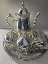 Silver plated tea set:  tea pot,  sugar & creamer set, butter dish and a tray
