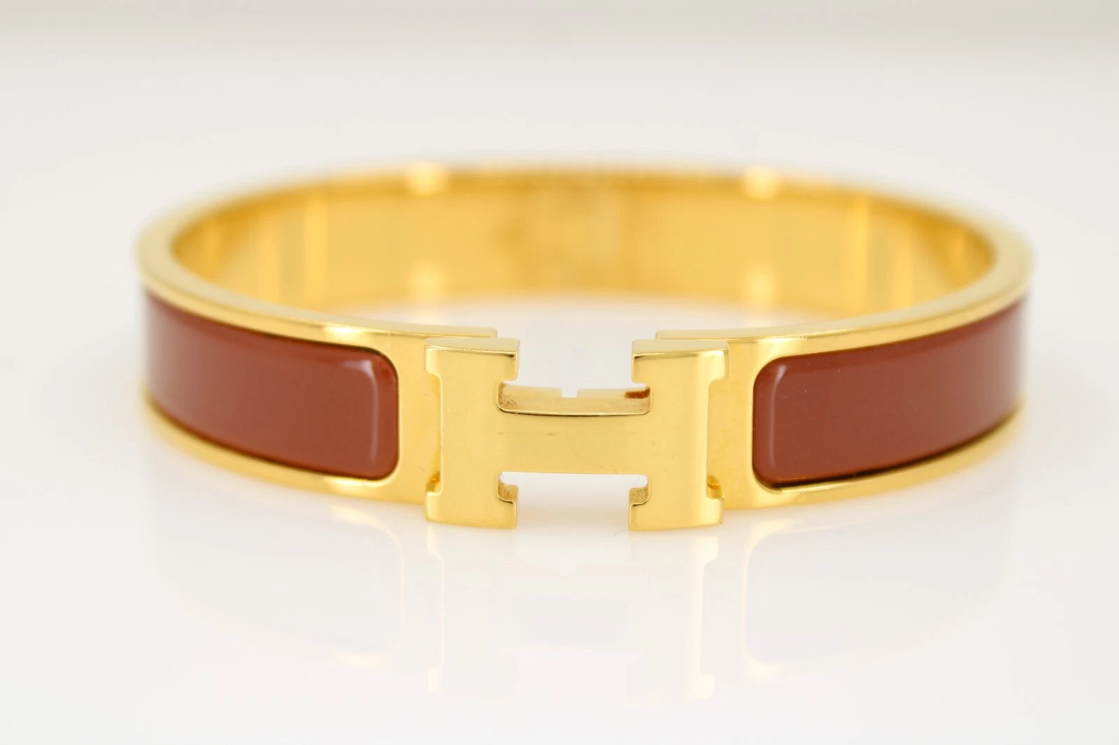 HERMÈS Bracciale stretto Hermes tono oro papaya smalto clic clac h misura 6 3 4"