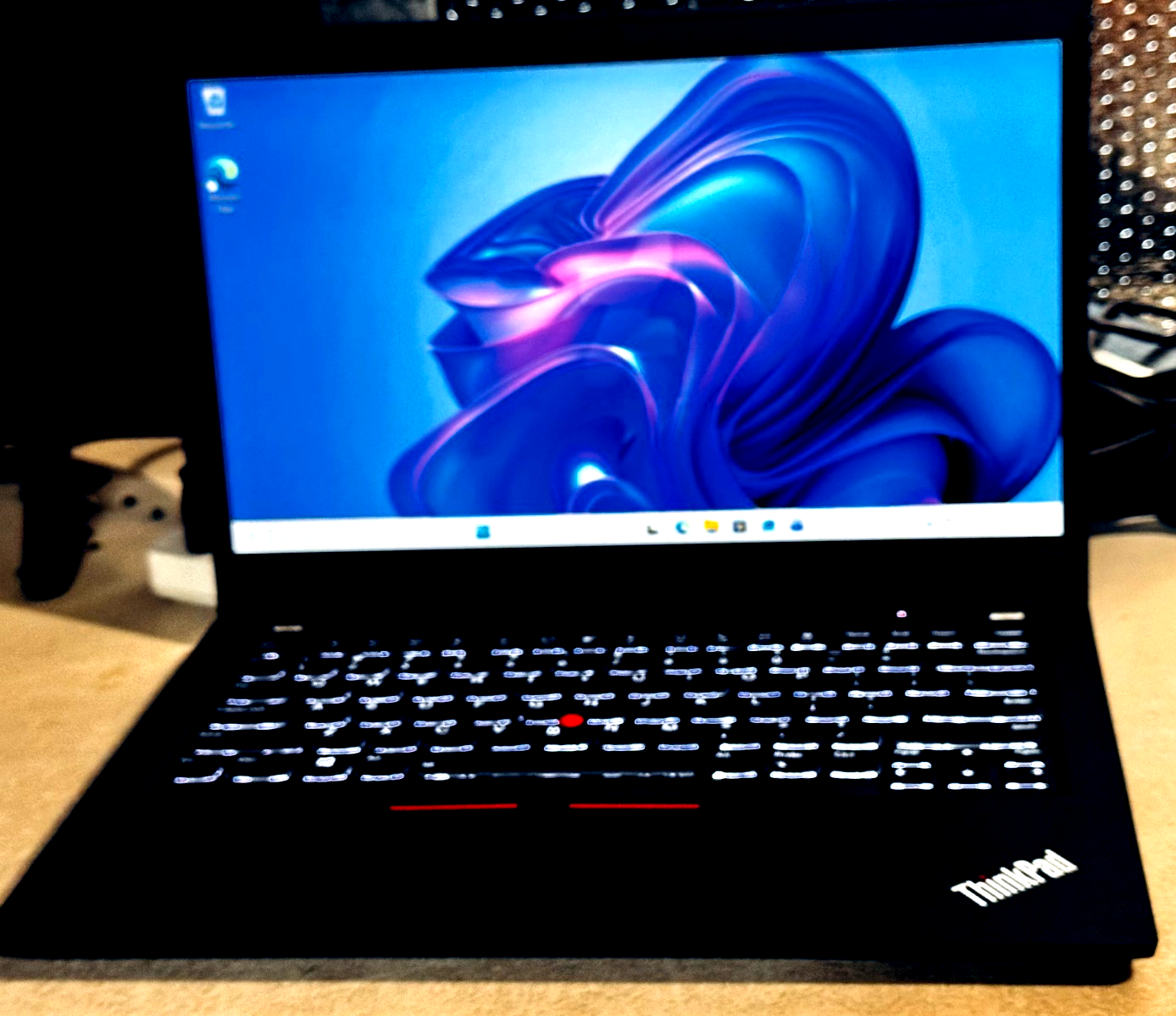 Black Lenovo ThinkPad P14S Gen 2 with touchscreen displaying colorful abstract background and red keyboard text.