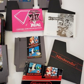 Lot of 8 NES Games Ikari Warriors II Jackal Trojan Strider Captain Comic CIB