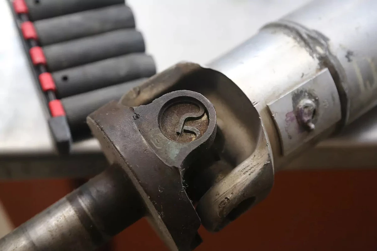 A closeup view of an outside clip of a vehicle's driveshaft.