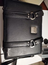 is a vintage Marsand USA black faux leather camera bag featuring a hard outer...