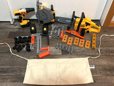 Toy power and wood working tools with nuts and bolts, nails, and wood pieces
