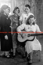 F019297 Ukrainian forced laborers singing before camp inmates Wearing OST patche