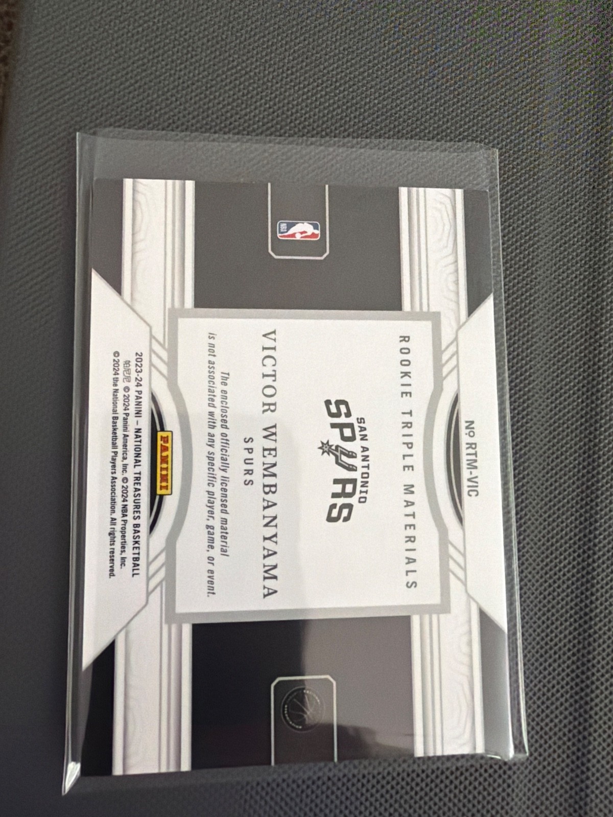 2023-24 Panini National Treasures  Rookie Triple Materials Victor Wembanyama /99 view 2