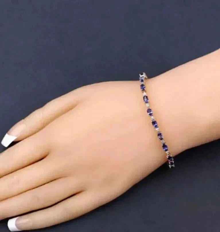 Brazalete de tenis de tanzanita azul de corte ovalado de 7 quilates enchapado en oro amarillo de 14 quilates Foto 4 de 4