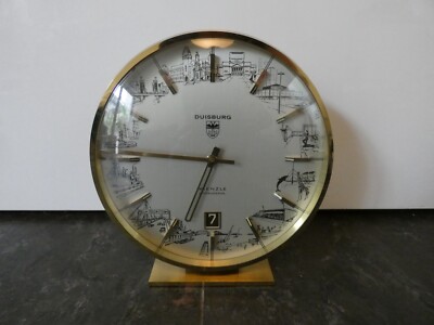 19118/ Kienzle Tischuhr 12 Ansichten von Duisburg Messing Datum Höhe ca. 18,5 cm