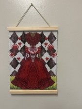 Dimond dot is a queen of hearts and it hangs on the wall