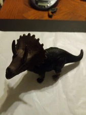 Dolgen Straight Dinosaur Black/gray 6.5 X3.5 Inches with red eyes.