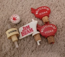 4 Vintage Pour Stoppers Jim Beam, Wolfschmidt Vodka (2), Seagram's Plastic as is