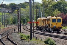 PHOTO  NETWORK RAIL TAMPING MACHINE LANCASTER RAILWAY STATION SEEN IN A SIDING A