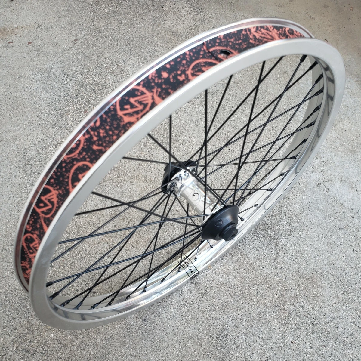 SHADOW CONSPIRACY SYMBOL FRONT WHEEL WITH HUB GUARDS 3 8