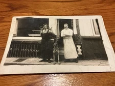 Vintage 1930s European Storefront Photo – Two Men with Dog, Baker & Worker