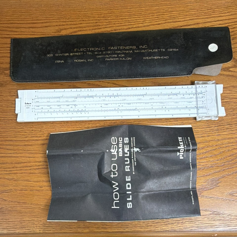A Pickett slide rule with its original branded case and manual is a complete, displayable artifact of pre-calculator engineering culture.