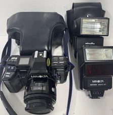 Minolta Maxxum 7000 AF 35mm SLR Film Camera W/ 50mm Zoom Lens, Flashes, & Case