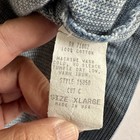 White vintage FSTOP label on blue denim vest, size XL, with yellow printed text and RN 71802 Made in U.S.A.