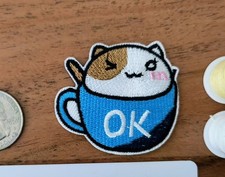 Cute Winking Cat In Blue Cup With "Ok" Text Patch Embroidered Iron On 1.80x1.97"