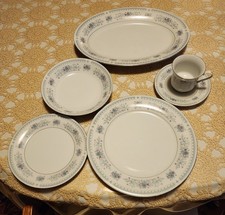 Floral pattern china place setting for 16, plus two serving platters