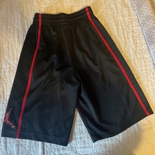 Jordan athletic shorts feature red side piping and a prominent Jumpman logo