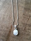 Sterling silver, beautiful oval shaped mother of pearl pendant and 16-18" chain.