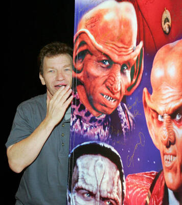 Actor Max Grodenchik poses next to a likeness of Rom the character - Old Photo