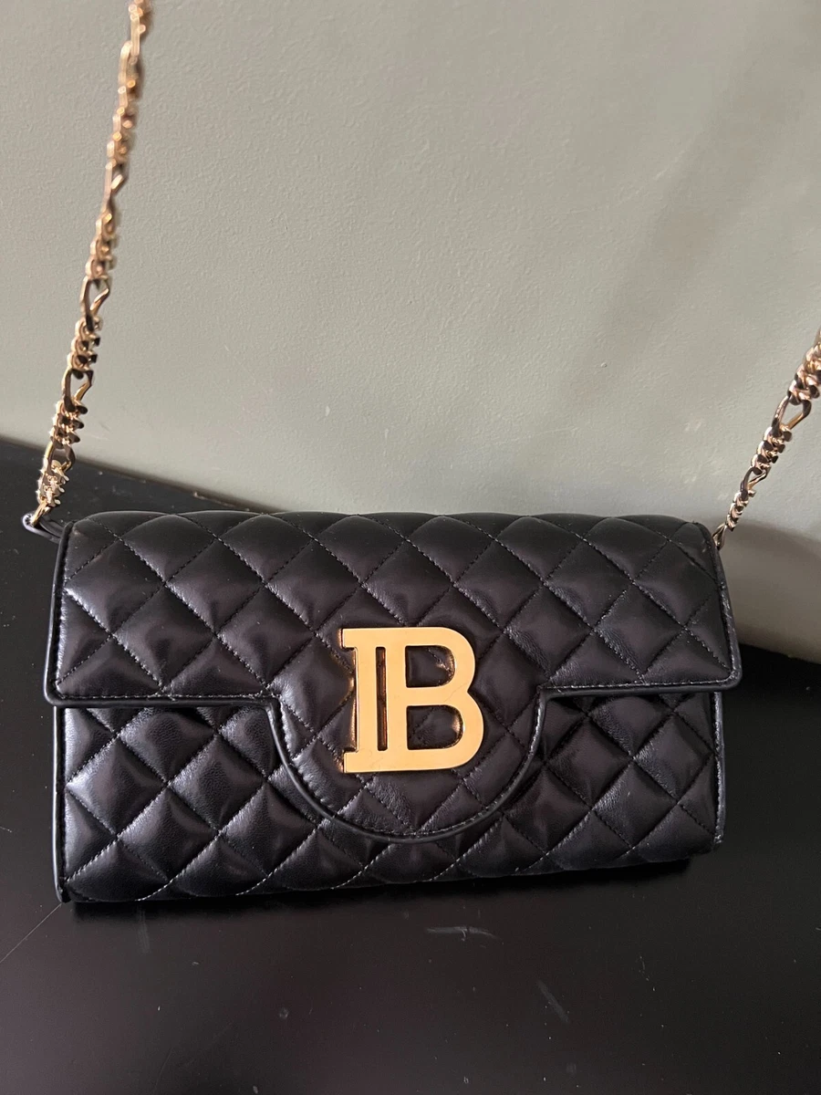 Black handbag top gold hardware