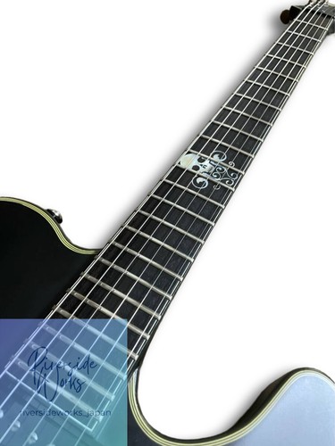 Black Schecter Blackjack SLS PT 2012 model with silver hardware, f-holes, and ornate blue pickguard with white diamonds.