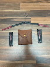 vintage set of collapsible travel hangers stored in a leather case