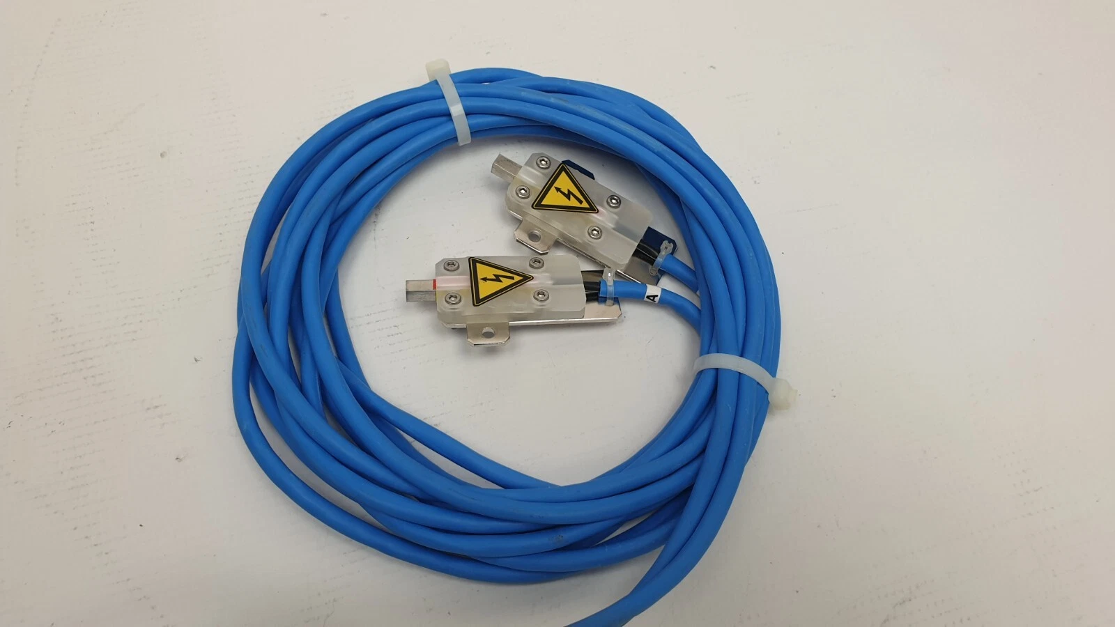 Coiled blue output cables with two high voltage terminal blocks