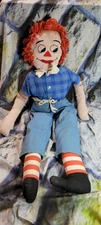 raggedy andy type doll with blue shirt and striped socks no tag with maker