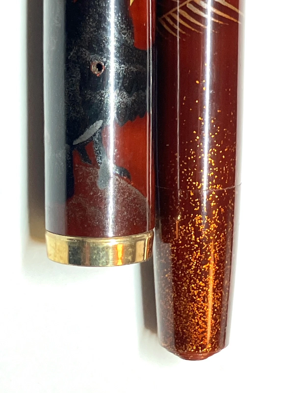 Vintage ink shut off fountain pen with gold bands, black body, and orange “URUSHIMA MAKIE” text on side.