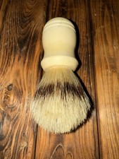 vintage cream-colored shaving brush with natural bristles.