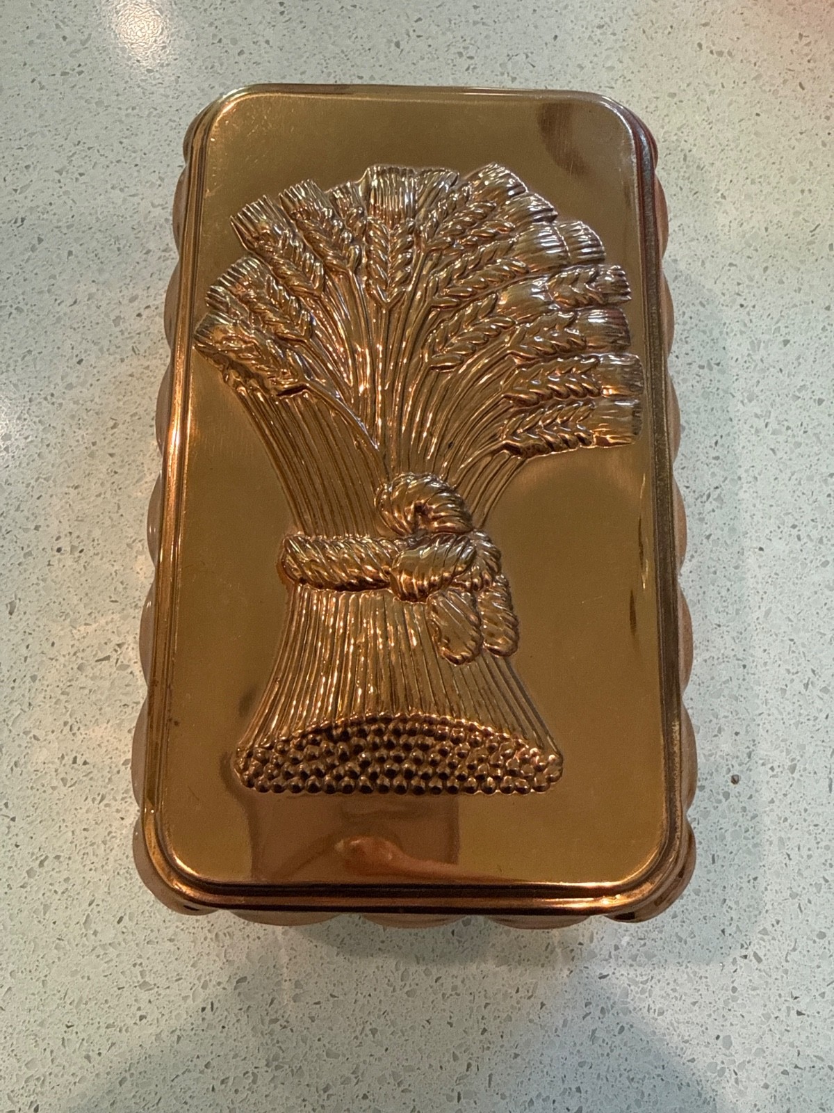 Rectangular copper wall mold embossed with a sheaf of wheat.