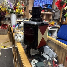 Vintage lampa kolejowa – oszałamiający zardzewiały czarny metal z czerwono-białymi akcentami