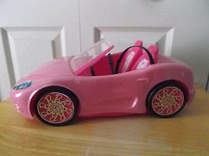 barbie doll and pink convertible